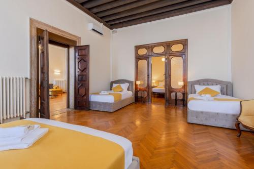 a large room with two beds and a table at View of Grand Canal Luxury Home - Station 5 minutes in Venice