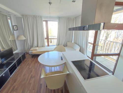 a living room with a table and a couch at Elegant, Suite, Swimming Pool in Wiesbaden