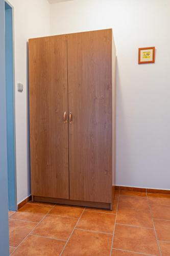 a wooden cabinet in the corner of a room at Penzion Ronox in Česká Skalice