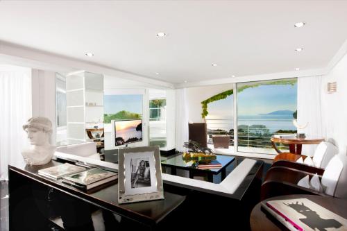 a living room with a couch and a table at Jumeirah Capri Palace in Anacapri