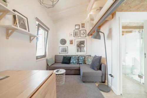 a living room with a couch and a table at Mezzanine Stylish Apartments by Vacationy in Porto