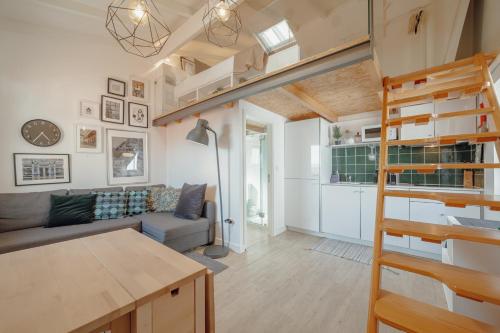 a loft apartment with a staircase and a living room at Mezzanine Stylish Apartments by Vacationy in Porto
