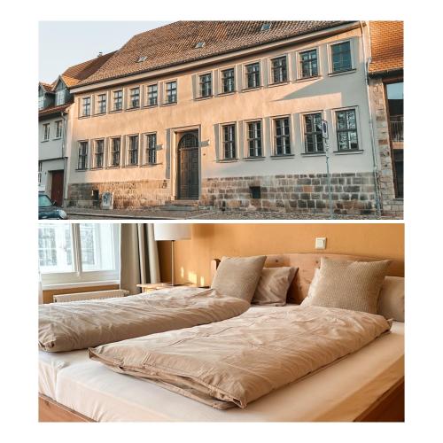 a bedroom with two beds in front of a building at Denkmalsuites Quedlinburg in Quedlinburg