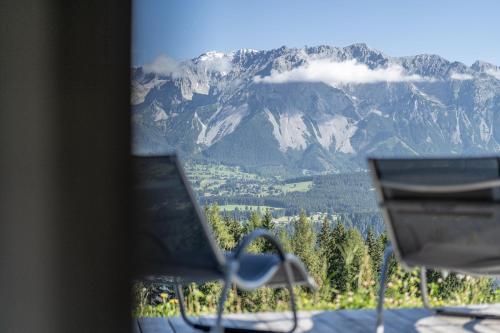a view of a mountain range from a chair at Hotel Winterer in Schladming