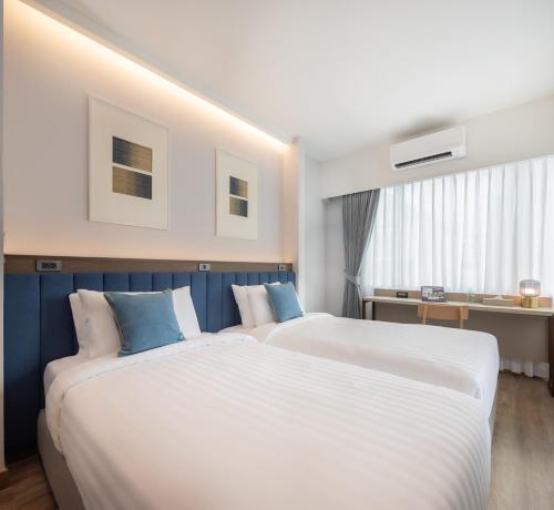 Ένα ή περισσότερα κρεβάτια σε δωμάτιο στο SOVA Hotel Bangkok