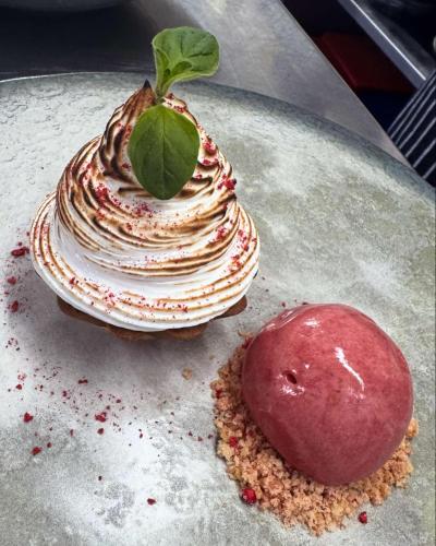 a dessert with a green leaf on top of it at Santo's Higham Farm Hotel in Alfreton