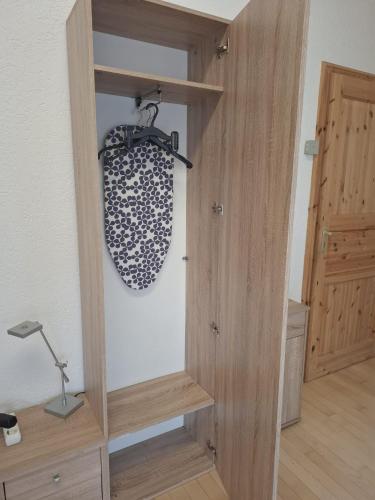 a room with a wooden closet with a shelf at Exclusive Apartments in Bietigheim-Bissingen