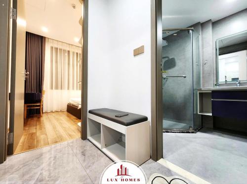a bathroom with a walk in shower and a sink at The LuxHomes Apartment ᵀᴹ I HOT Độc Đáo Nhất Vinhomes Marina in Hai Phong