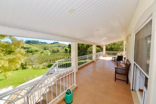 an empty porch with a view of the countryside at Casa Bianca in Caldas da Rainha