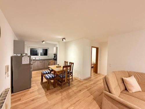 a kitchen and dining room with a table and a couch at Casa Grande mit 3 Apartments in Rastatt