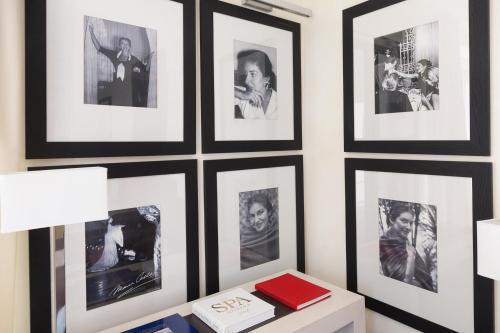 a wall with framed pictures on a wall at Jumeirah Capri Palace in Anacapri