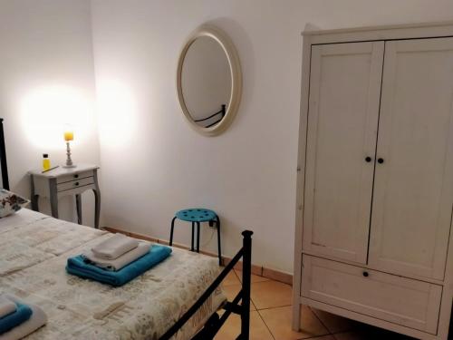 a bedroom with a bed with a mirror and a stool at Terry Road House in Monterotondo