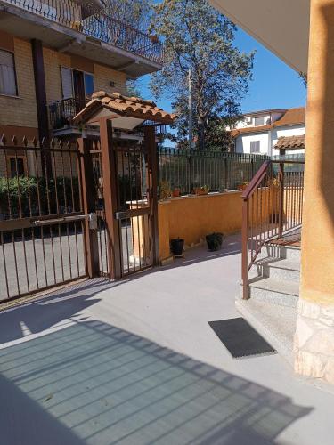 an entrance to a house with a fence and an umbrella at Terry Road House in Monterotondo