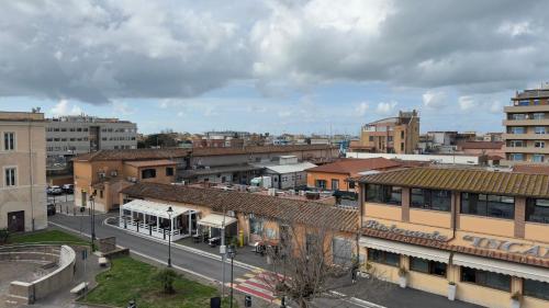 a view of a city with buildings and a bus at Centro storico - Ottimo Collegamento aeroportuale e Roma in Fiumicino