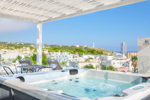 a hot tub on a balcony with a view at Le Cammire Luxury Apartment - Leuca in Leuca