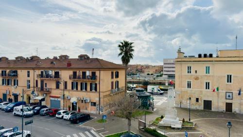 a city with cars parked in a parking lot at Centro storico - ottimi collegamenti per Roma e APT in Fiumicino