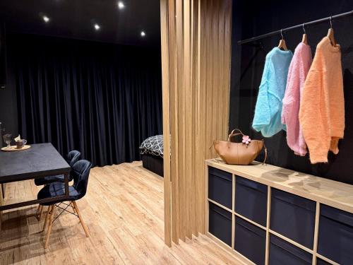 a dressing room with a table and a chair and towels at Vila GARUFA Wellness & Spa in Vysoké Tatry