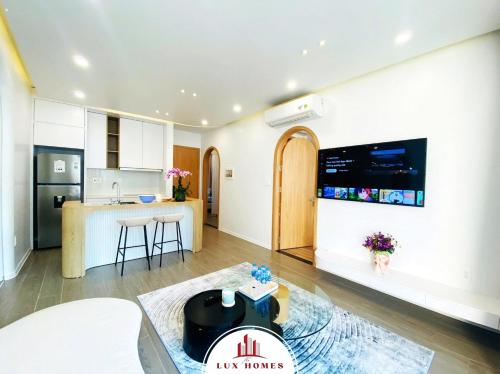a living room with a kitchen and a counter at The LuxHomes Apartment ᵀᴹ I HOT Độc Đáo Nhất Vinhomes Marina in Hai Phong