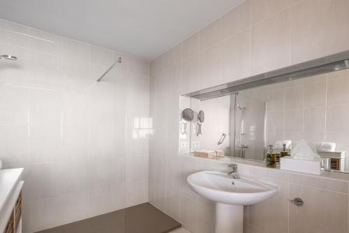 a white bathroom with a sink and a mirror at Villa Poniente Montiboli by Buccara in Villajoyosa
