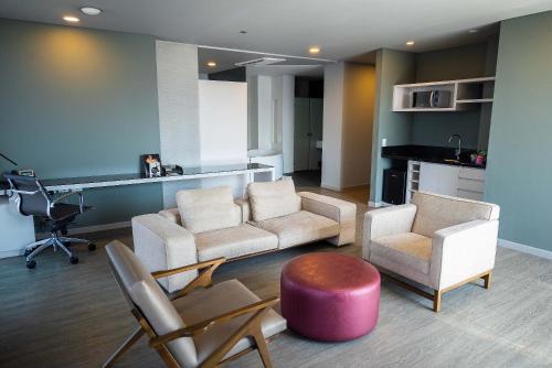 a living room with a couch and chairs and a table at Hotel Black Tower Premium in Bogotá