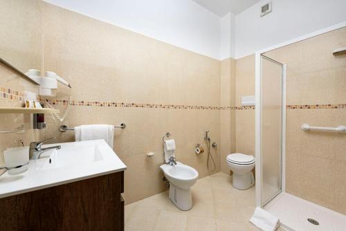 a bathroom with a toilet and a sink and a shower at Hotel La Darsena in San Vito lo Capo