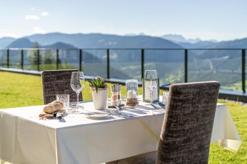 a white table with chairs and wine glasses at Hotel Winterer in Schladming