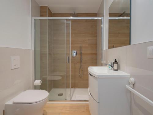 a bathroom with a shower and a toilet and a sink at Luxury apartment - Flumendosa 5 in Milan
