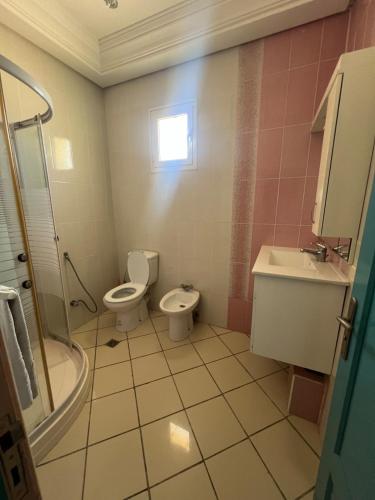a bathroom with two toilets and a sink at Dream Villa with Private Pool in Taguermess