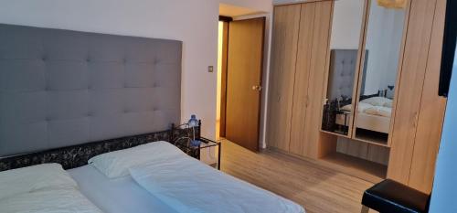a bedroom with a bed and a large mirror at Hotel Castel Latemar in Carezza al Lago