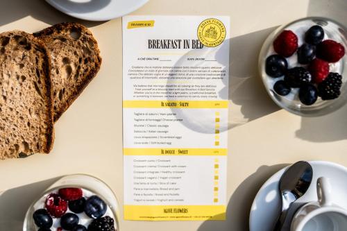 a menu for breakfast in bed with toast and berries at Agave in Centrale in Milan