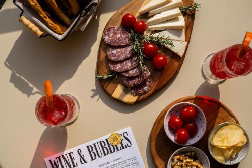 a table with a plate of meat and cheese at Agave in Centrale in Milan