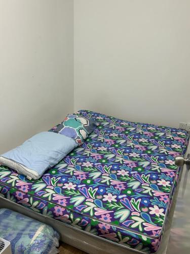 a bed with a colorful blanket on it in a room at Ady's 737 in Kuala Lumpur