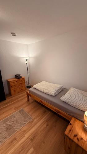 a bedroom with two beds and a table and a lamp at Casa Grande mit 3 Apartments in Rastatt