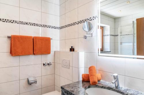 a bathroom with a sink and a mirror at Alpenblick Tilly - Fewo Barmsee 2 in Krün