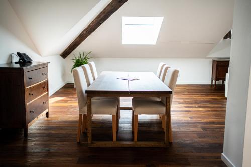 a dining room with a wooden table and chairs at Agave in Centrale in Milan