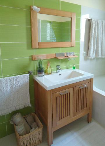 a bathroom with a sink and a mirror and a tub at The best sea view in Madeira - Casa Farol in Fajã da Ovelha