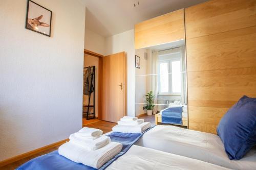 a bedroom with two beds with towels on them at Special ROGER F RABBIT 2 Apartment, Roche Towers, 10-STAR in Basel