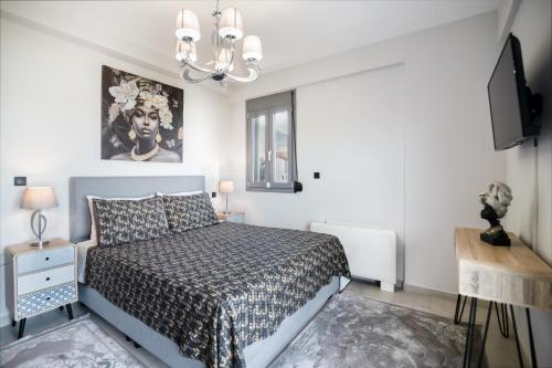 a bedroom with a bed and a chandelier at marYsol luxury maison in Eantio