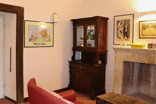 a living room with a grandfather clock and a fireplace at Palazzo D'Alessandro Wunderkammer & Suites B&B di charme in Caporciano