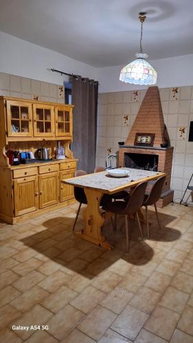 a kitchen with a table with chairs and a stove at Casa bolsena in Gradoli