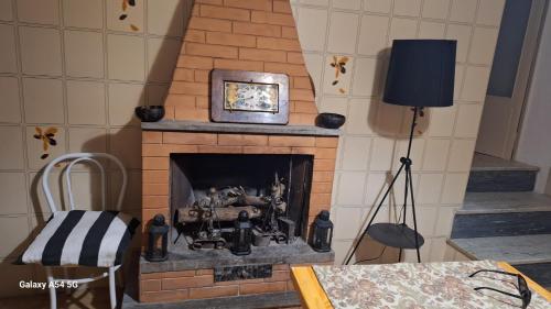 a fireplace with a clock on top of it at Casa bolsena in Gradoli