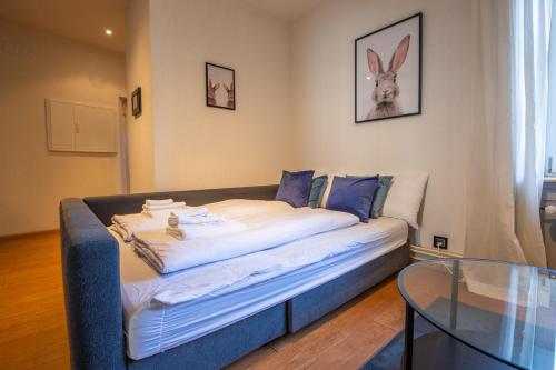a bed in a room with a glass table at Special ROGER F RABBIT 2 Apartment, Roche Towers, 10-STAR in Basel