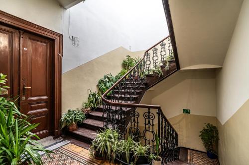 a staircase in a building with potted plants at ShortStayPoland Old Town C1 in Kraków