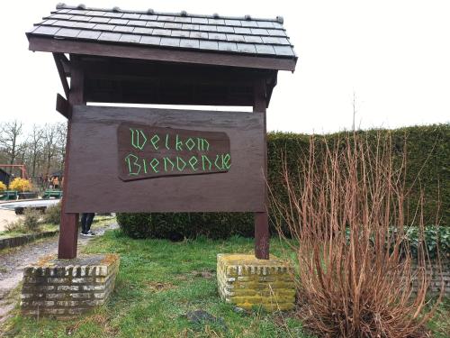 a sign that says welcome back to a park at Chalet HEUREux in Somme-Leuze