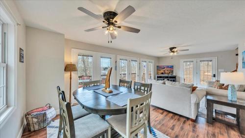 a dining room and living room with a table and chairs at Lakefront 3BR with Dock, Fire Pit, Lawn Games, and Game Room in Moneta