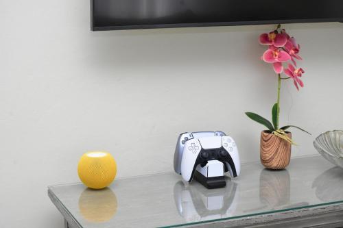 a table with a radio and a vase with a flower at Experience Luxury & Serenity-Your Perfect Getaway in Ocho Rios