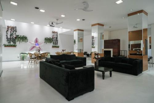 a living room with black couches and a table at Hotel Normandie in Sao Paulo