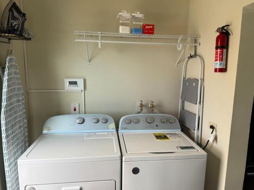 a laundry room with a washer and dryer at Experience Luxury & Serenity-Your Perfect Getaway in Ocho Rios
