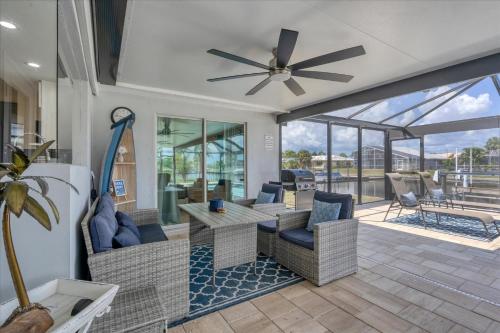 a living room with a ceiling fan and a patio at BVC280 Punta Gorda Isles in Punta Gorda