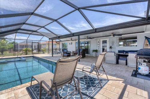 a patio with chairs and a swimming pool at BVC280 Punta Gorda Isles in Punta Gorda